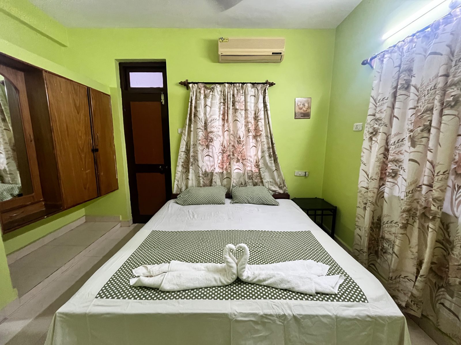 Standard Room with AC, wardrobe and made bed